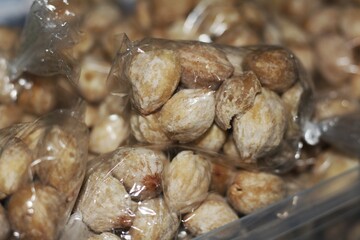 close up of candlenuts in plastic