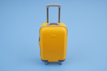 Suitcase on blue background. Travel concept.