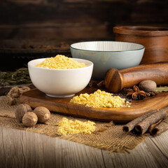 MUSTARD POWDER YELLOW on wooden table background. Herbs, spices and dried food baking ingredient. Mortar and different spices. Cottage kitchen. Product Photography