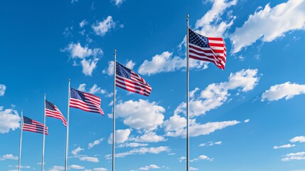 American flags flying on tall poles against a blue sky