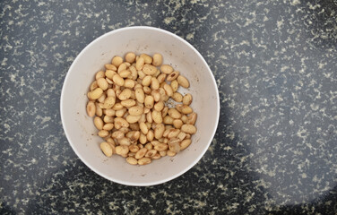 A picture of a bowl full of soybean, which high in protein content.