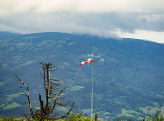torn windsock with storm on the mountain in the background