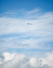 a sailplane in the air above the clouds
