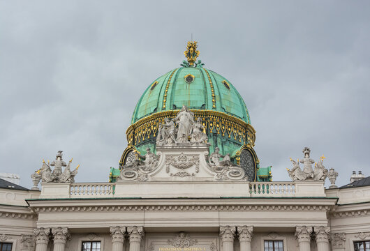 View of the dome and the sculptures of the Hofburg palace complex.