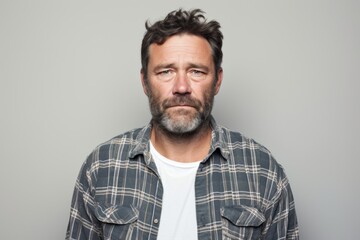 Fototapeta premium Portrait of a jovial man in his 40s wearing a comfy flannel shirt over plain white digital canvas