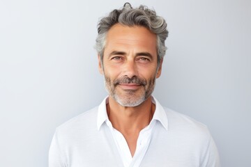 Obraz premium Portrait of a satisfied man in his 50s wearing a chic cardigan isolated on plain white digital canvas