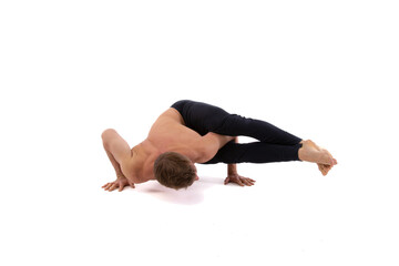 A young attractive man is doing yoga. White background.