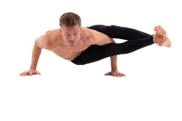 A young attractive man is doing yoga. White background.