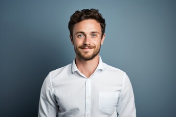 Fototapeta premium Portrait of a glad man in his 30s wearing a simple cotton shirt in plain cyclorama studio wall