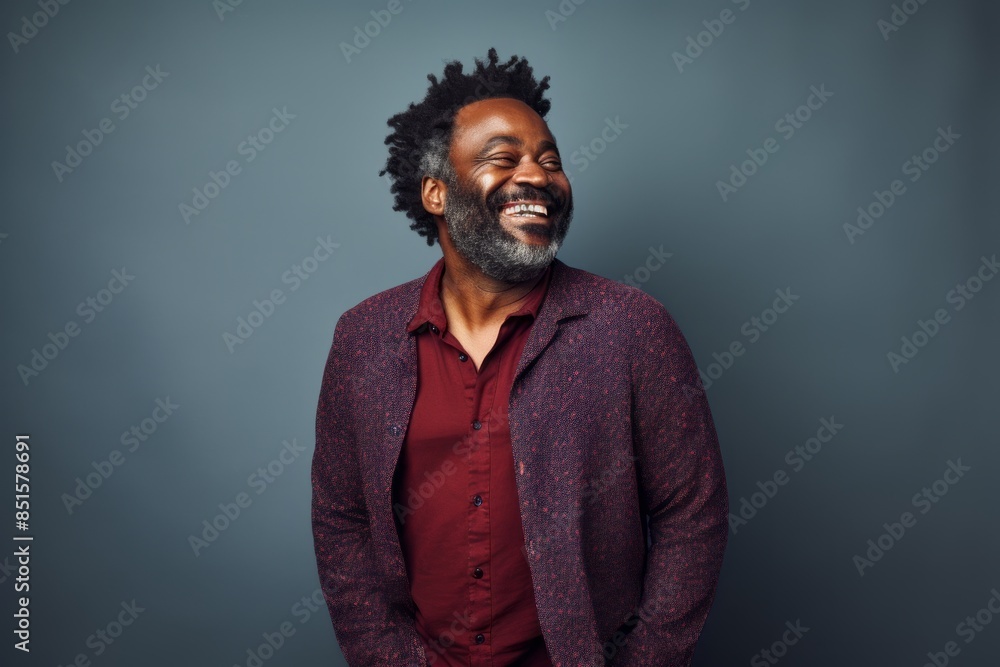 Canvas Prints portrait of a jovial afro-american man in his 40s wearing a chic cardigan in front of plain cycloram