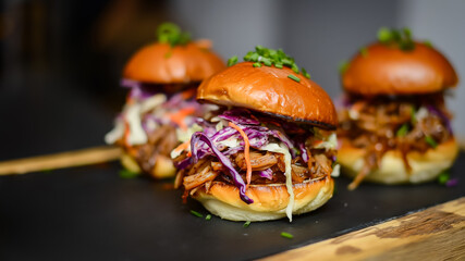 Savory pulled pork slider with a tangy coleslaw topping 