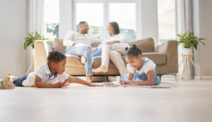 Relax, family and kids in lounge, happy and learning of children, girl and smile of writing in notebook. Playful, boy and toy on floor, parents and together on couch, joy and rest for weekend in home