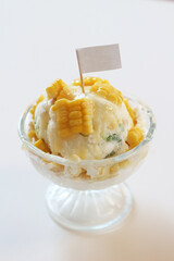 Corn ice cream in glass bowl with flag