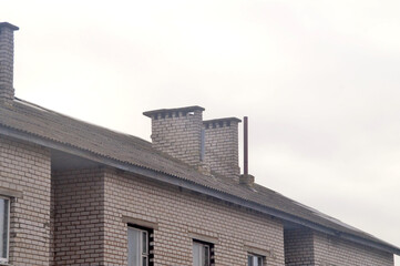 Brick chimneys on the roof of a residential building
