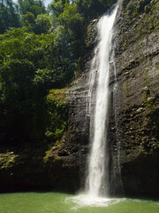 Green plunge basin with flowing water. Alalum Falls. Bukidnon, Philippines.