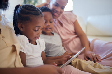 Tablet, girl child and ebook in living room on weekend for live streaming or storytelling for mom and dad. Children, woman and online in lounge for love and watching movies or videos together in home