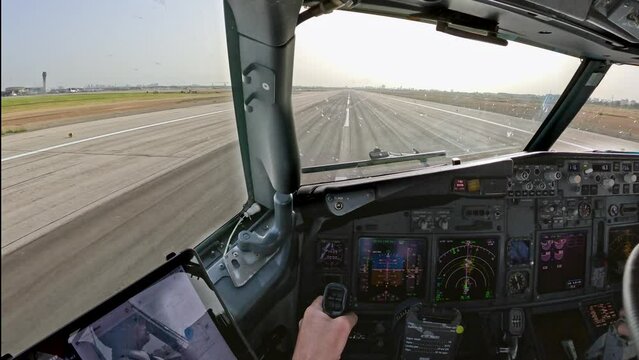take off or takeoff seen forward view from cockpit of aircraft, airplane, jet plane from holiday destination, travel spot coast line with beach and many instruments and controls on the flight deck