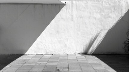 Obraz premium A sun shade shadow is cast over the white concrete wall