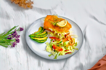 Smoked Salmon with Avocado and Fresh Salad on a Light Background with Decorative Flowers and Leaves