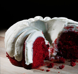 White frosting on a red velvet cake