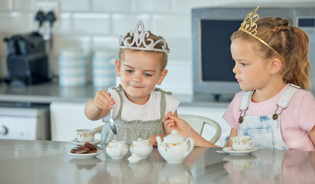 Girl, children and playing in kitchen with tea party for childhood fun, cookies and tiara for pretend. Kids, siblings and toys in home with happiness or love, bonding and growth or development.