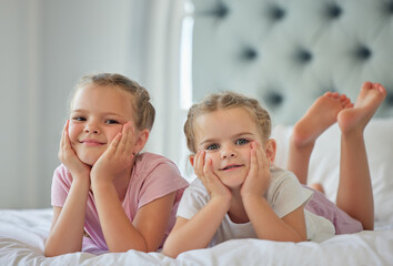 Sisters, kids and portrait to relax in bedroom, morning and wake up together in home. Girls,...