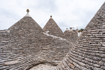 Conical roofs of the famous old dry stone trulli houses in Alberobello. Italy