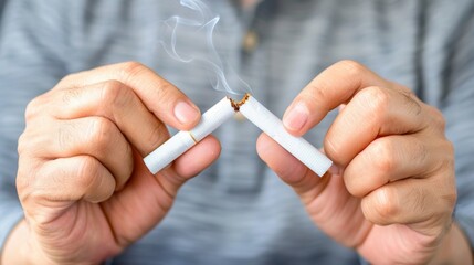 Quitting smoking concept with broken cigarette in hands
