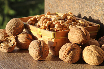 Whole walnuts and shelled kernels in a basket