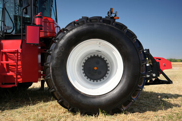 Close-up of the rear wheel of a large heavy farm tractor.