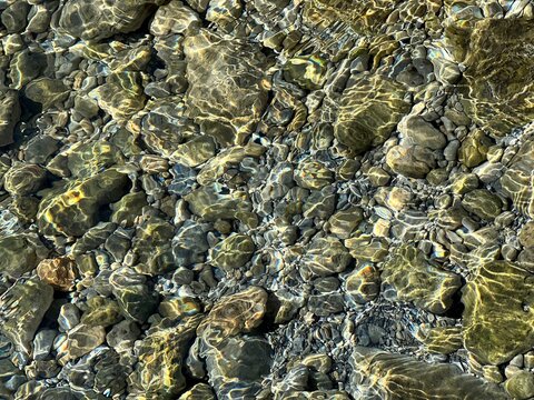 Clear water with pebbles stones at the bottom of the sea.