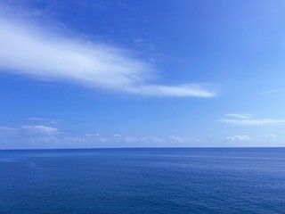 Blue sea, sunny sky, white clouds.
