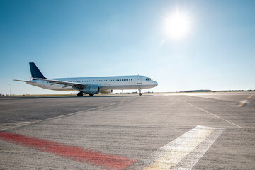Commercial airplane during taxiing on taxiway to airport runway for take off on sunny day..