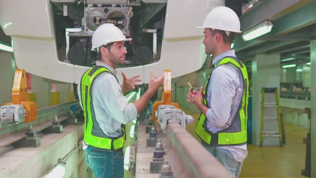 Engineers check the readiness of electric train tracks at the maintenance factory.
