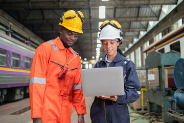Railway Engineers Collaborating with Laptop on Site