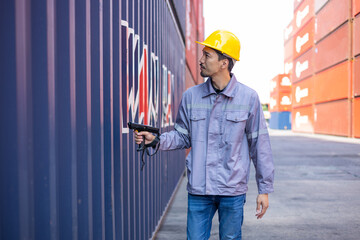 Portrait of an engineer inspecting products using a barcode scanner. Container import and logistics concept