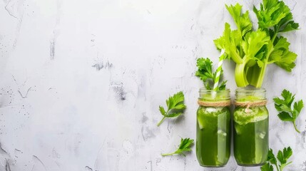 Fresh celery juice in mason jars on a white rustic background