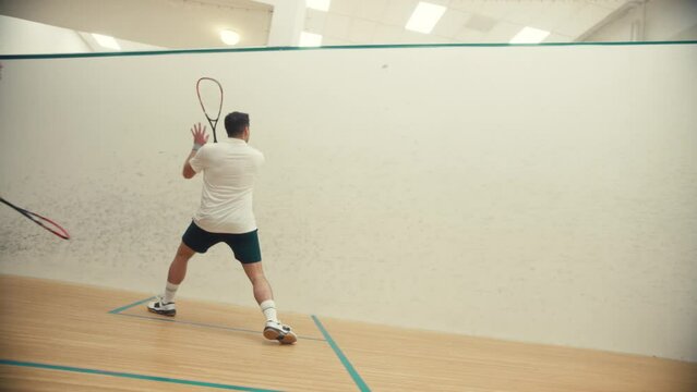 Side view of two squash players