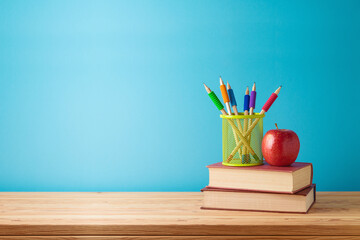 Back to school concept with books, pencils, apple and empty space table for product display