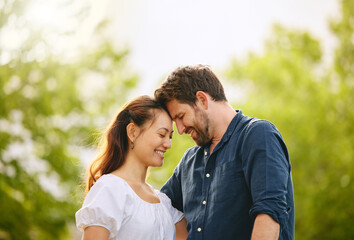 Couple, forehead touch and love in garden, connection and romance in relationship or affection....