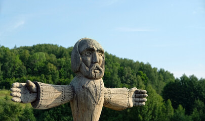 old wooden pagan idol in forest, natural background. god totem in traditional Slavic folk style....