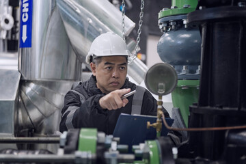 worker in factory. People in Industrial interior chiller and boiler HVAC heating ventilation air...
