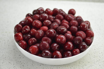 Red cherry in a bowl. Red sweet cherry background.