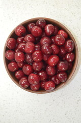 Red cherry in a bowl. Red sweet cherry background.