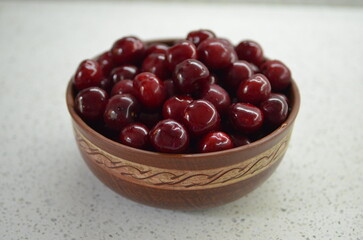 Red cherry in a bowl. Red sweet cherry background.
