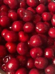 Red cherry in a bowl. Red sweet cherry background.