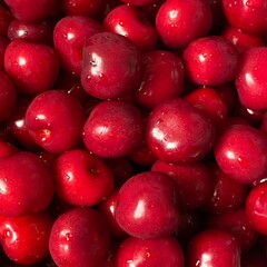 Red cherry in a bowl. Red sweet cherry background.