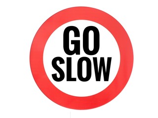 A sign with a red circle and the words 'Go slow,' serving as a warning to drivers to reduce their speed for safety reasons and to avoid potential dangers