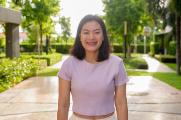 Portrait of beautiful Asian woman outdoor in park during summer