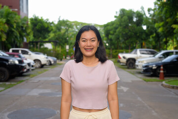 Portrait of beautiful Asian woman outdoor in parking lot during summer